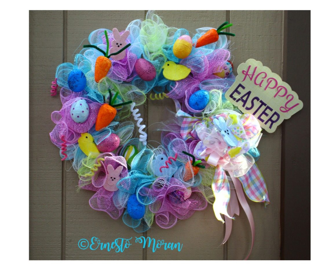 Handmade pastel Easter wreath with eggs and carrots